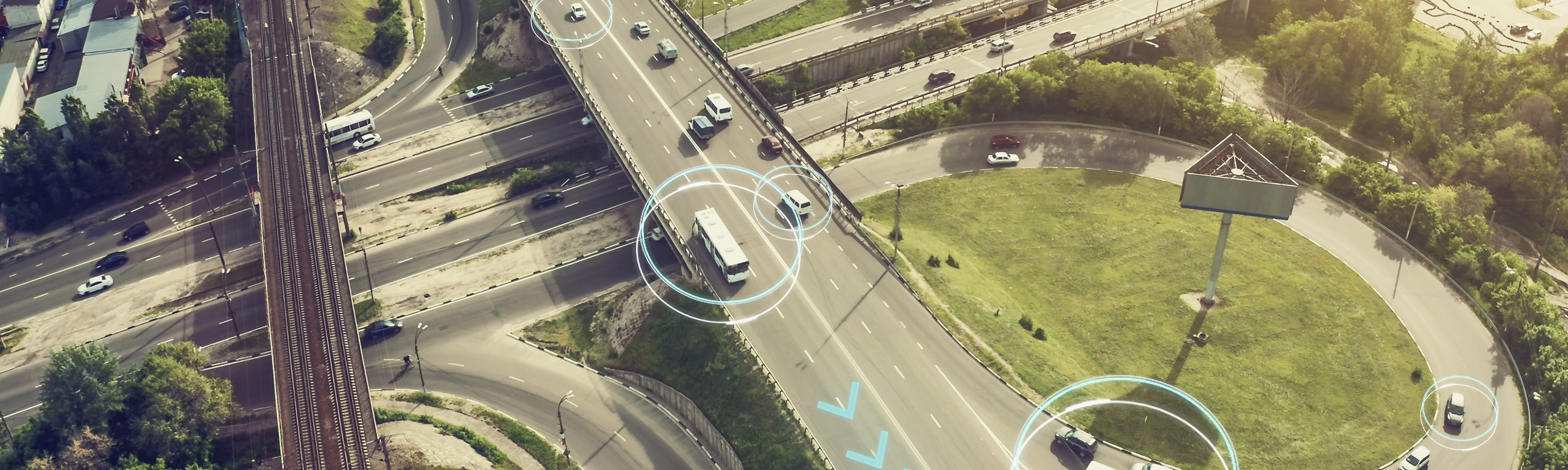 Aerial view of a highway interchange with marked autonomous vehicles.