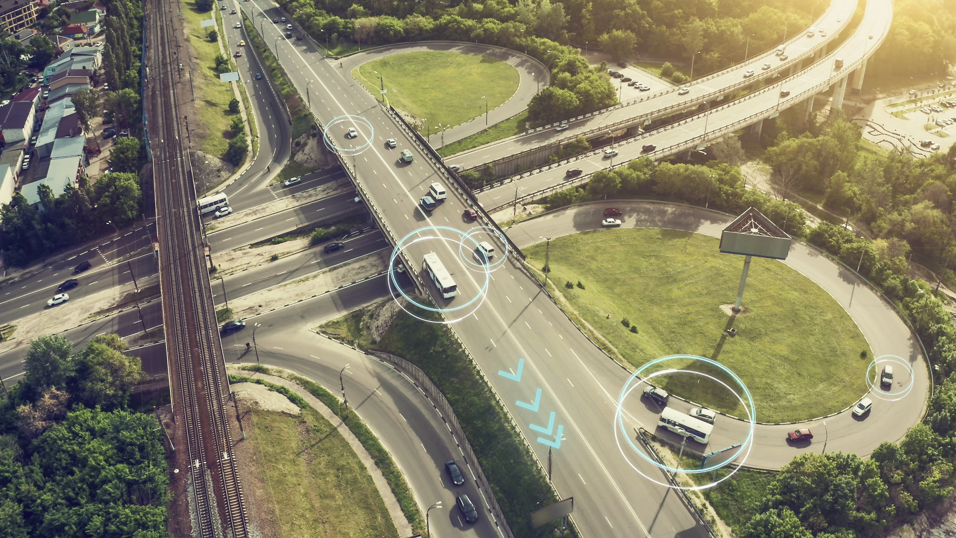Aerial view of a highway interchange with marked autonomous vehicles.
