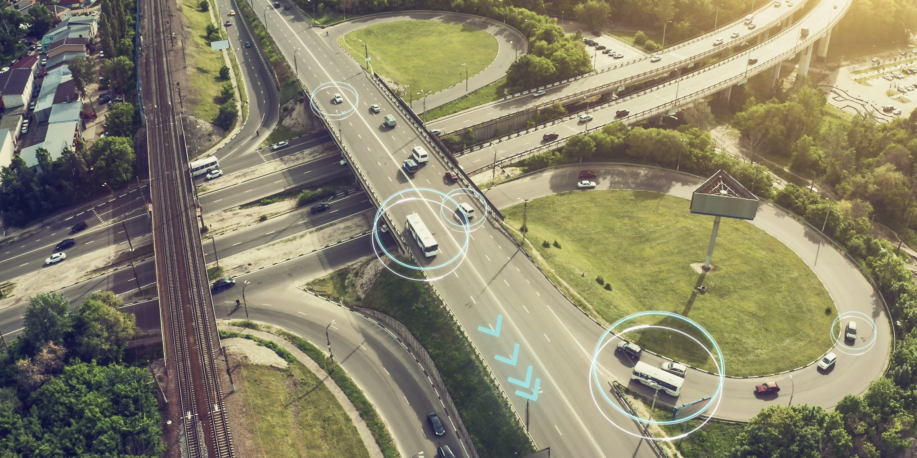 Aerial view of a highway interchange with marked autonomous vehicles.