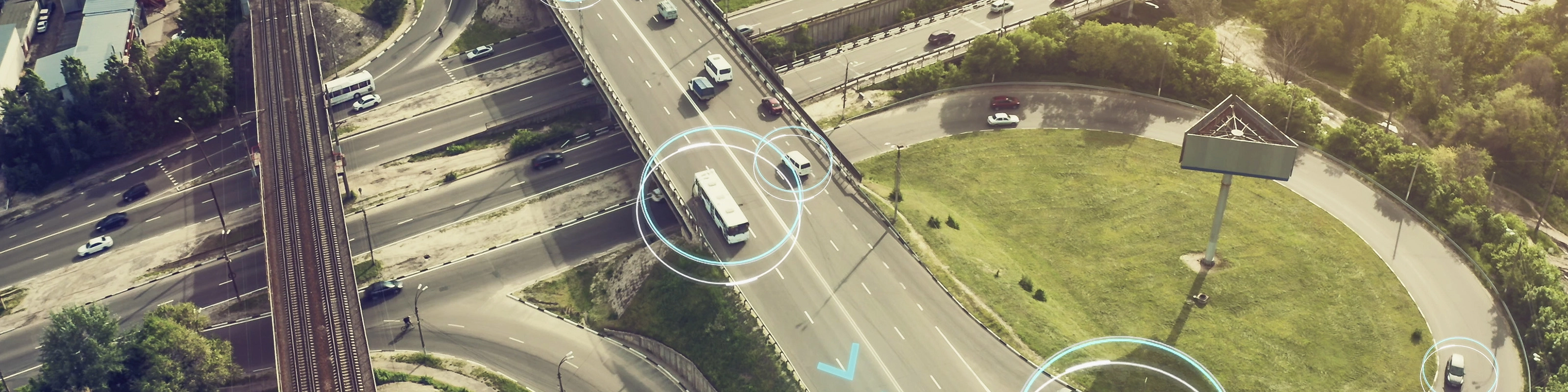 Aerial view of a highway interchange with marked autonomous vehicles.