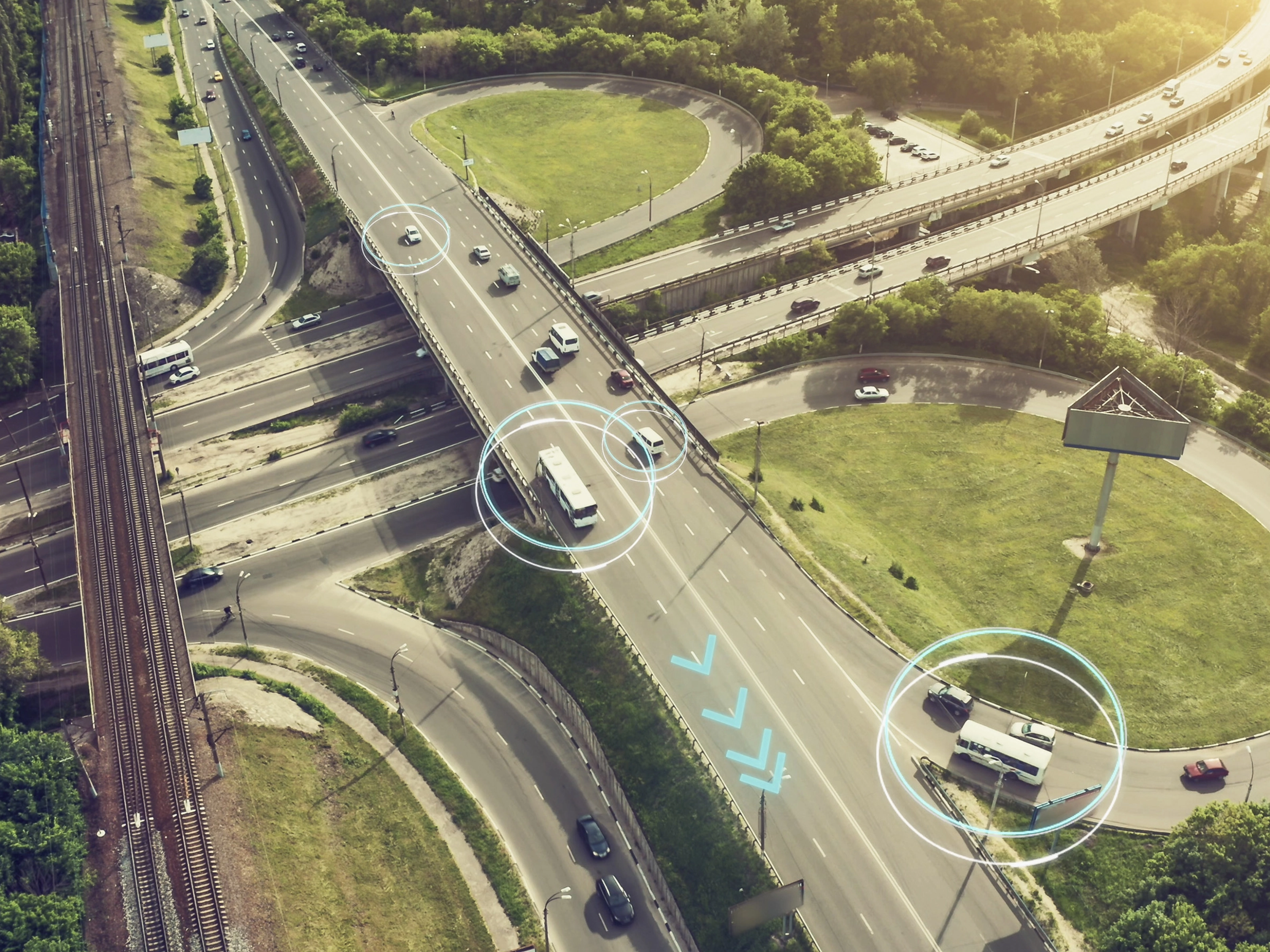 Aerial view of a highway interchange with marked autonomous vehicles.