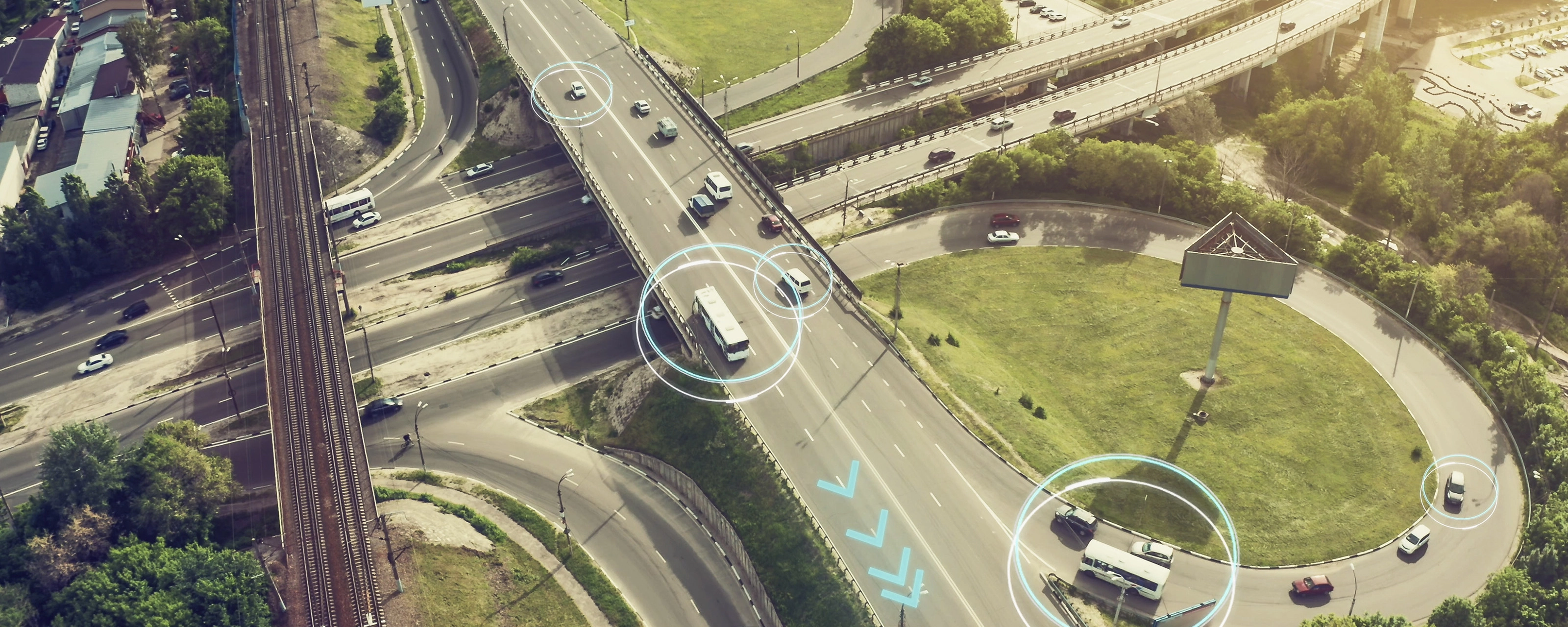 Aerial view of a highway interchange with marked autonomous vehicles.